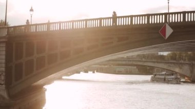 the ship sails under the bridge overlooking Notre Dame
