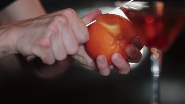 Bartender cleans orange for cocktail — Stock Video