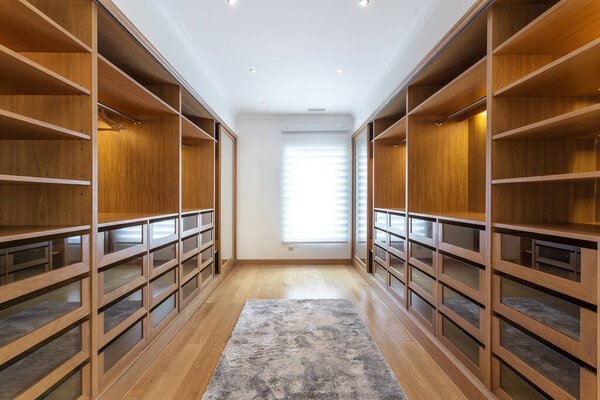 Large wardrobe room, with empty shelves. In house