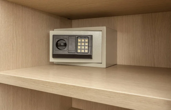 Safe box for storing valuables in a wooden cupboard. Inside