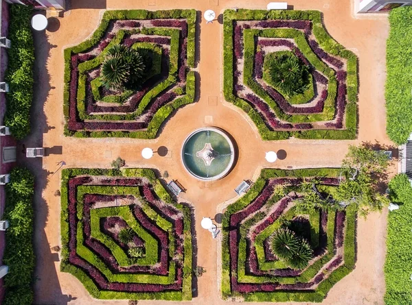 Ornamental garden with a fountain. Shot a dron from above.