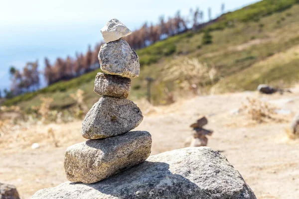 Balanced stones stand in the hill on the mountain Monchique. Portugal
