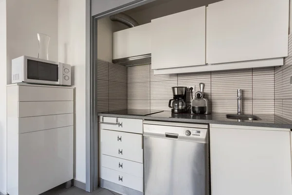 Modern white kitchen with electrical accessories. European design.