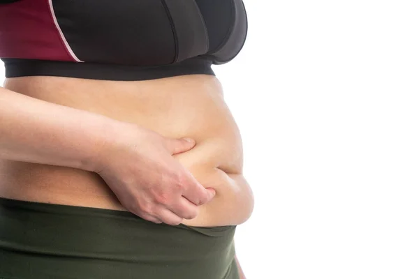 Kobieta z grubymi fałdami na brzuchu. Koncepcyjny obraz otyłości. Widok z boku. zbliżenie, izolowane na białym tle. — Zdjęcie stockowe