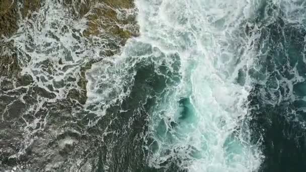 Vídeo aéreo nostálgico, en cámara lenta del mar, las olas rodan suavemente a orillas rocosas del Océano Atlántico Pacífico. — Vídeos de Stock