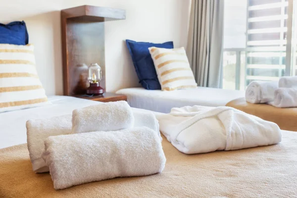 Ložnice s moderní postelí a ručníky v popředí. Evropský hotelový design. Detailní záběr. — Stock fotografie