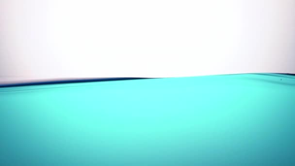 A pure blue wave of water, in a half calm state, a symbol of purity, freshness and ecology. Close-up. — Stock Video