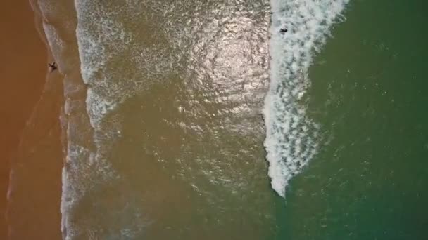 Videoaufnahmen aus der Luft. Türkisfarbene Wellen waschen den Sand sanft. Arrifana, Sagres, Portugal, Algarve. — Stockvideo
