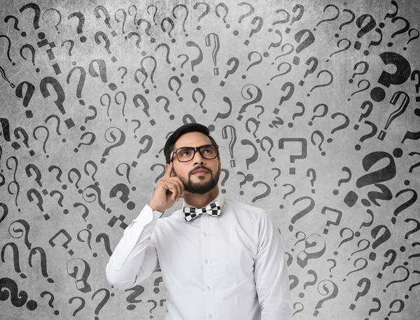 Shocked businessman with question marks — Stock Photo, Image