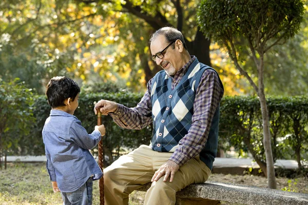 Loving grandfather playing with his grandson at park — Stock Photo, Image
