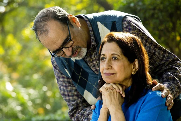 stock image Man comforting senior woman at park