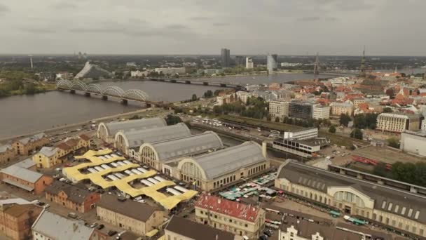 Riga, Lotyšsko - květen, 2019: Letecký pohled na centrální trh Rigy a staré centrum Rigy u řeky Daugavy. — Stock video