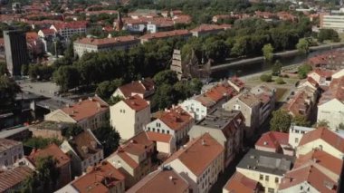 KLAIPEDA, LITHUANIA - JULY, 2019: Aerial flight view of the sailboat Meridianas in the river Dane in old city of Klaipeda.