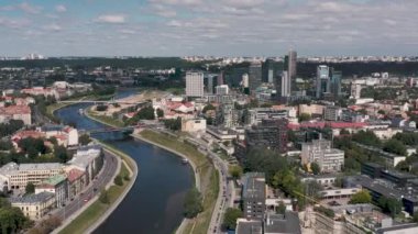 VILNIUS, LITHUANIA - JULY, 2019: Aerial view of the Neris river crossing the industrial and ancient quarters of Vilnius.