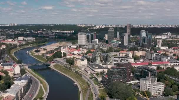 VILNIUS, LITHUANIA - JULY, 2019: Aerial view of the Neris river crossing the industrial and ancient quarters of Vilnius. — ストック動画