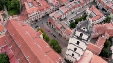 VILNIUS, LITHUANIA - JULY, 2019: Aerial drone view of the St. Johns church with Bell tower and roofs of the old city.