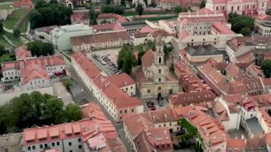 VILNIUS, LITHUANIA - JULY, 2019: Aerial drone view of the roofs old city centre and church of Mother of God in Vilnius.