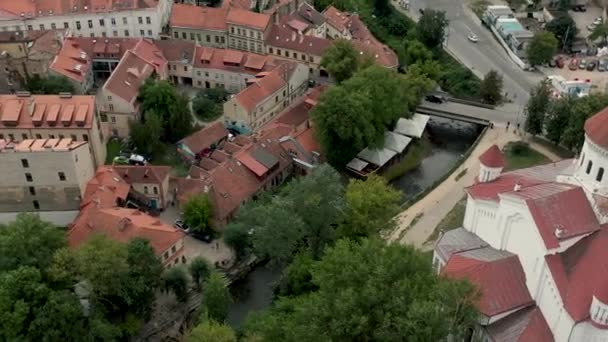 VILNIUS, LITHUANIA - JULY, 2019: Aerial drone view of the Dormition cathedral and roofs of Uzupis district in Vilnius. — Stock Video