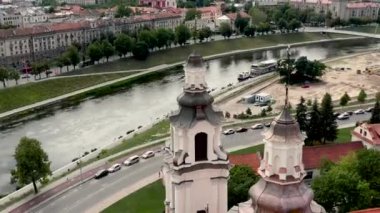 VILNIUS, LITHUANIA - JULY, 2019: Aerial view of the towers Archangel Raphhaels church and promenade of the Neris river.