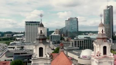 VILNIUS, LITHUANIA - JULY, 2019: Aerial view of the towers Archangel Raphhaels church and Vilnius business center.