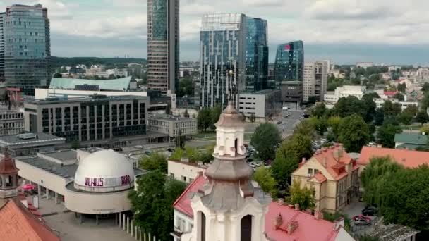VILNIUS, LITHUANIA - JULY, 2019: Aerial view of the dome Archangel Raphhaels church and Vilnius business center. — ストック動画