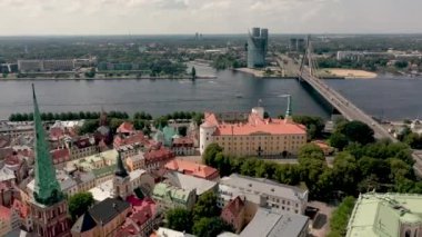 RIGA, LATVIA - MAY, 2019: Aerial top view of the Vansu bridge over Daugava river and roofs of the old city centre of Riga.