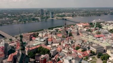 RIGA, LATVIA - MAY, 2019: Aerial view of the famous cathedrales and roofs in old city centre of Riga and Daugava river.
