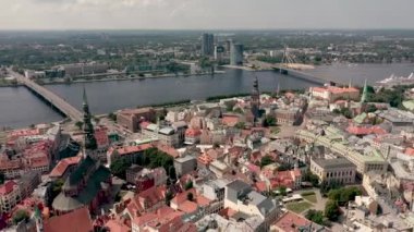 RIGA, LATVIA - MAY, 2019: Aerial view of the famous cathedrales and roofs in old city centre of Riga and Daugava river.