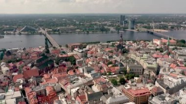 RIGA, LATVIA - MAY, 2019: Aerial view of the famous cathedrales and roofs in old city centre of Riga and Daugava river.