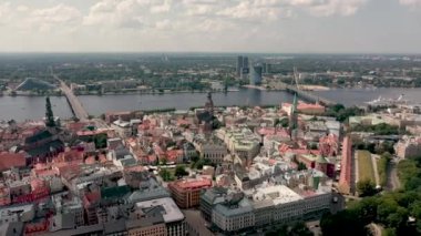 RIGA, LATVIA - MAY, 2019: Aerial view of the famous cathedrales and roofs in old city centre of Riga and Daugava river.