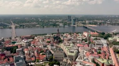RIGA, LATVIA - MAY, 2019: Aerial view of the famous cathedrales and roofs in old city centre of Riga and Daugava river.