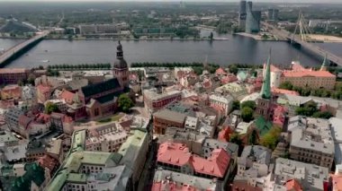 RIGA, LATVIA - MAY, 2019: Aerial view of the spiers Rigas cathedrales and roofs old city centre near the Daugava river.