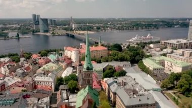 RIGA, LATVIA - MAY, 2019: Aerial view of the St. Jacobs cathedral and roofs old city centre of Riga near Daugava river.