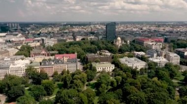 RIGA, LATVIA - MAY, 2019: Aerial top view of the city landscapes with roofs of houses, park and ancient Rigas churches.