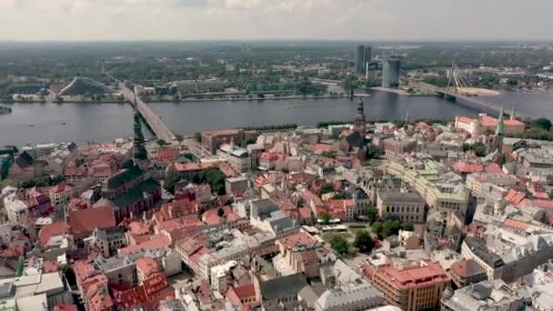 RIGA, LATVIA - MAY, 2019: Aerial view of the famous cathedrales and roofs in old city centre of Riga and Daugava river. — Stock video