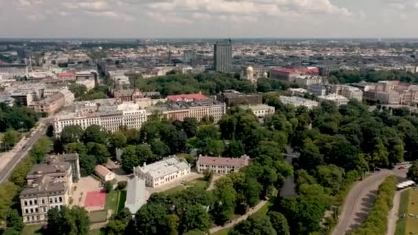 RIGA, LATVIA - MAY, 2019: Aerial top view of the city landscapes with roofs of houses, park and ancient Rigas churches. — Stock video