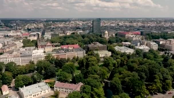 RIGA, LATVIA - MAY, 2019: Aerial top view of the city landscapes with roofs of houses, park and ancient Rigas churches. — Stockvideo