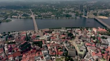RIGA, LATVIA - MAY, 2019: Aerial panorama view of the old city centre of Riga and stone bridge over the Daugava river.