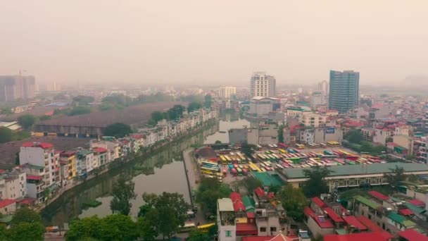 HANOI, VIETNAM - APRIL, 2020: Aerial panorama view of the bus station near canal and cityscape of Hanoi. — Stock Video