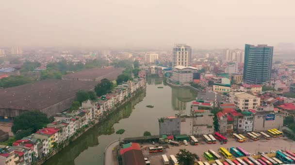 HANOI, VIETNAM - APRIL, 2020: Aerial panorama view of the bus station near canal and cityscape of Hanoi. — Stock Video