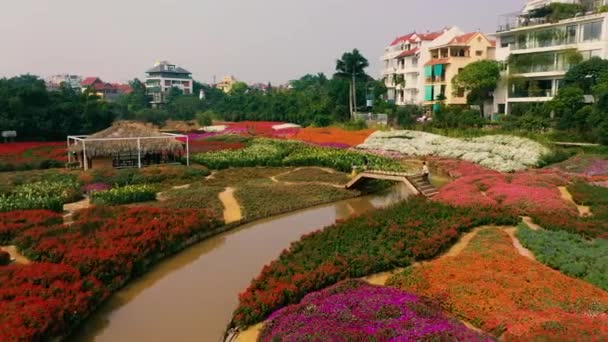 HANOI, VIETNAM - APRIL, 2020: Aerial drone view of the flower garden with verandas and canal near west lake of Hanoi. — Stock Video