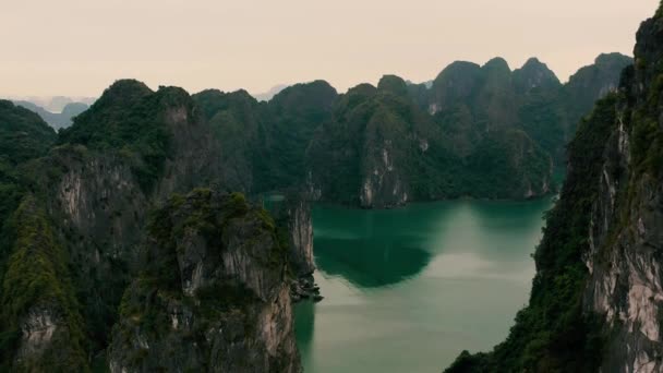 АЛОНГ-БЕЙ, ВЬЕТНАМ - АПРЕЛЬ, 2020: Воздушный панорамный вид на каменные острова с тропическими лесами залива Халонг во Вьетнаме . — стоковое видео