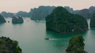HALONG BAY, VİETNAM - 2020: Vietnam 'da Halong Körfezi tropikal ormanları olan kayalık adaların gökyüzü manzarası.