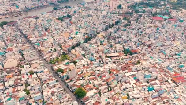 HOCHIMINH, VIETNAM - APRIL, 2020: Aerial top view on the roofs of houses in the densely populated district of Hochiminh. — Stock Video