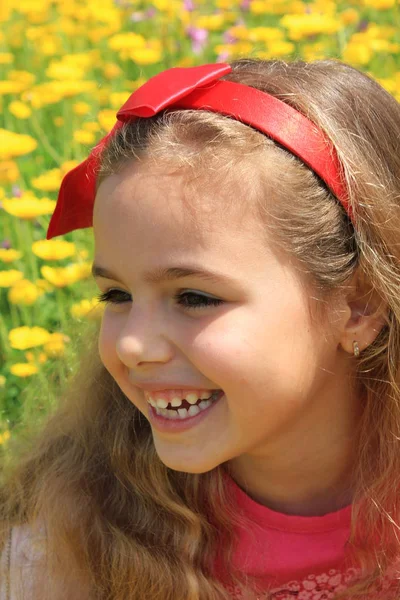 Menina feliz sorrindo em um jardim flores amarelas — Fotografia de Stock