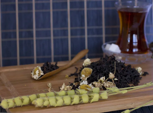 Black leaf tea with chamomile in traditional turkish glass