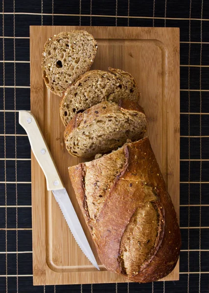 Pão de centeio com cereais na mesa de madeira — Fotografia de Stock