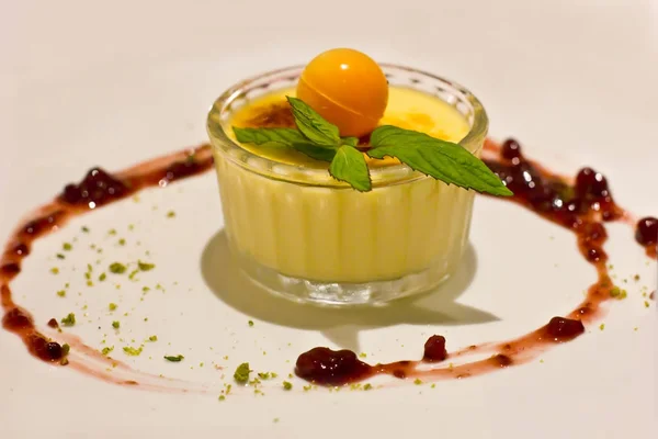 Creme brulee with a ball of white chocolate and mint — Stock Photo, Image