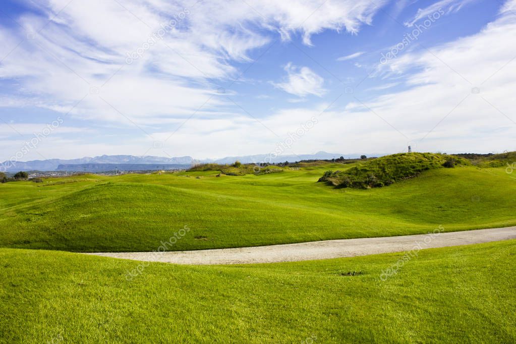 Golf course in Belek. Green grass on the field. Blue sky, sunny 
