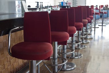 Bir uzun sayaç ve yüksek kırmızı sandalye bar Bar